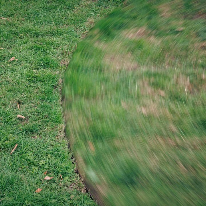 Close-up of a lawn that has a circular, rotating shape cut into it.